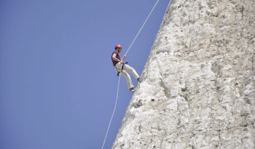 A photo of a person abseiling down the Peacehaven Cliffs
